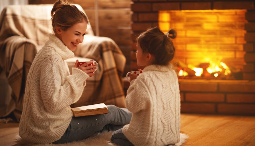Mom and Daughter Enjoying the Fireplace at Home - Cates Heating and Cooling