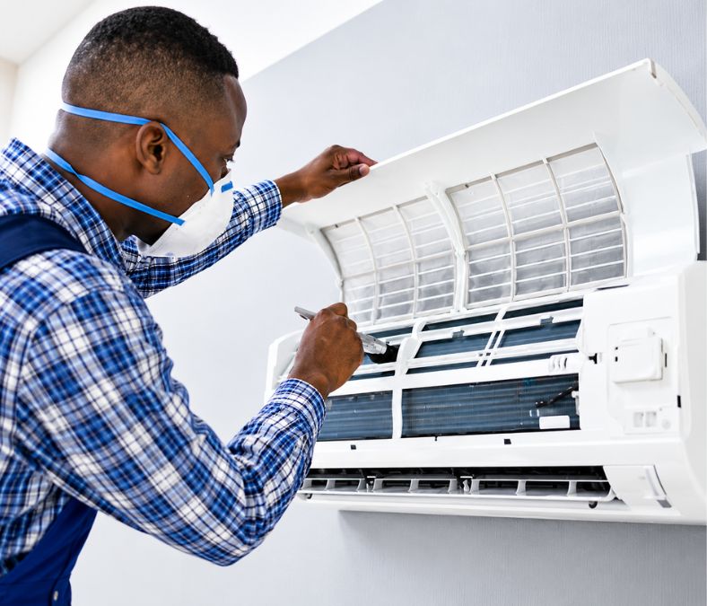 HVAC technician performing AC service in Lenexa KS on an air conditioning system.