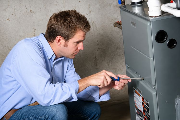Technician completing routine furnace service in Lenexa, KS