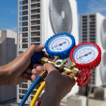 Air,Conditioning,Service,Technician,Using,Measuring,Manifold,Gauge,Checking,Refrigerant Cates technician working on rooftop units in overland park.